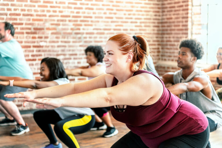 people-doing-squats-in-fitness-class-2023-11-27-05-16-30-utc